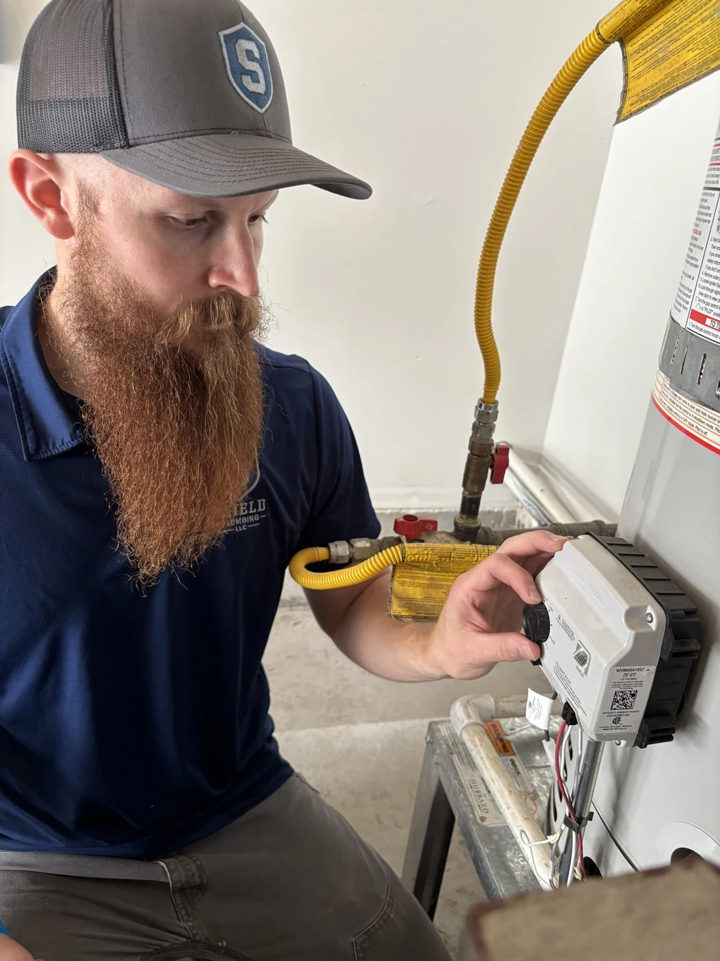 Will Mortensen adjusting a residential water heater control